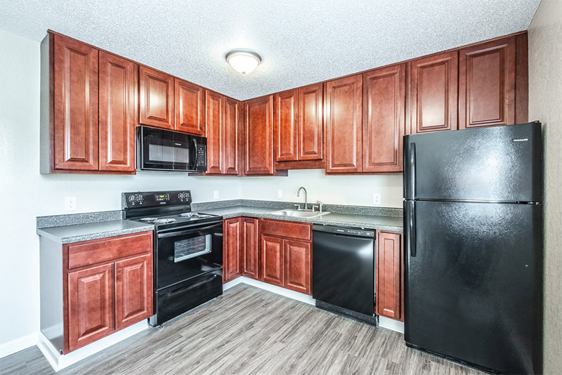 A renovated Harbor Pointe kitchen with new cabinets and black appliances