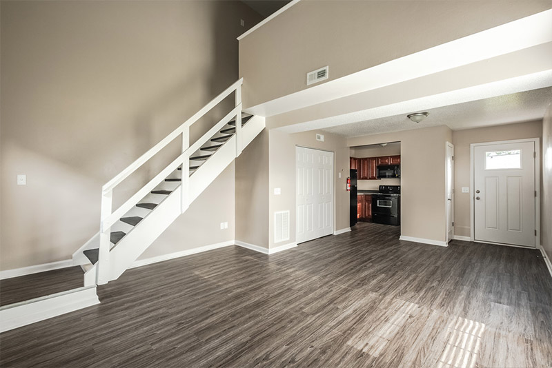 The stairs and open living area of a two bedroom loft at Harbor Pointe
