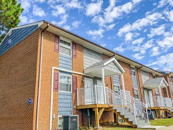 A brick building with balconies and white stair rails