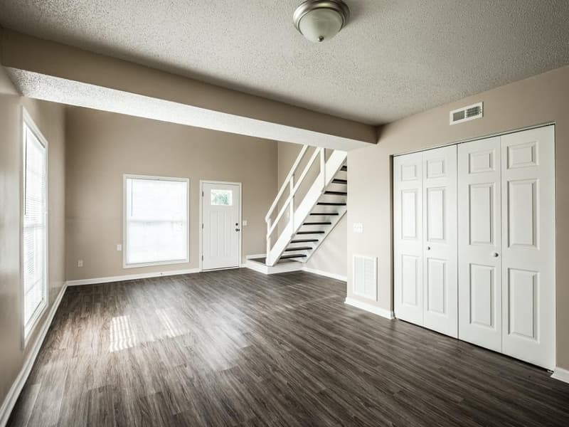 A one-bedroom loft at Harbor Pointe, stairs rising from the living area