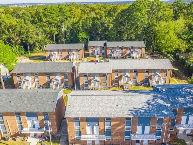 Two-bedroom buildings among mature trees