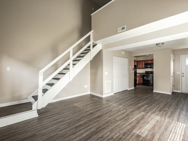 An open living area with the loft stairs behind it